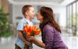 © BillionPhotos.com - Little child presenting flowers to mother, Mother's Day