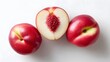 © pkproject - Three fresh white nectarines one sliced to reveal juicy pink flesh and pit  Presented on a clean white studio background highlighting their healthy appeal