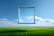 © MichaelMob - Surreal white picture frame floating over a vast green grass field under a bright blue sky with fluffy clouds, representing vision, perspective, and creative freedom in a conceptual landscape.