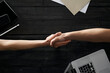 © Westend61 - Partners shaking hands in office