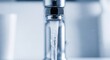 © AGUNG - Close-up of a chrome faucet with water cascading down, blurry background