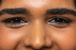 © Wavebreak Media - Extreme close-up eye area is showing black eyeliner, lashes, pores under warm studio lighting