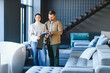© Serhii - Couple choosing fabric swatches for new home sofa