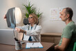 © Nenad - Woman doctor reviewing lung radiography with patient in clinic