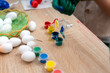 © andov - Children decorate Easter eggs with colors on a wooden table during spring season at a local community event