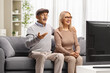 © Ljupco Smokovski - Surprised mature couple watching a show on television