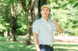© buritora - Male golfer using smartphone at golf course (app, score, score management, course strategy, course map)