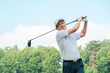 © buritora - Male golfer playing golf on a golf course (smiling, tee shot, golf competition)