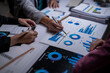 © apichat - Business people analyzing financial data charts in meeting
