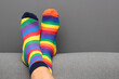 © Arlette - Feet with mismatched socks, different colors and designs for World Down Syndrome Day, to highlight inclusion and the uniqueness of each person