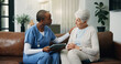 © WesJVR/peopleimages.com - Tablet, nurse and old woman in home for support, homecare and healthcare with news in retirement. Caregiver, elderly person and comfort with technology in house, medical wellness or diagnosis results