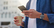 © peopleimages.com - City, hands and person with phone for chat, scroll and browse online or internet. Outdoor, tech and coffee with connection and mobile app for social media, networking and text message to contact