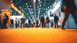© Ashi - Colorful blurred busy trade show hall with orange carpet, people walking and networking in large exhibition center, business fair environment, international marketing and professional networking event