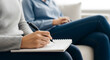 © Loka Design - Professional Female Therapist Taking Notes During a Mental Health Consultation Session