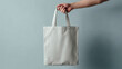 © PACHARA - A person is holding a white bag