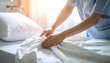 © Tarring - Nurse Hands Smoothing White Bed Sheets in Hospital Room, Healthcare Assistant Preparing Patient Bed in Clinic, Professional Medical Housekeeping Service