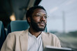 © Amy - Business traveler with glasses commuting by train and looking out the window
