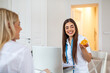 © Graphicroyalty - Professional Nutritionist Holding Orange Slice During Consultation with Client in Bright Office. Female Dietitian Explaining Healthy Eating Habits and Vitamin C Benefits While Using Laptop Computer.