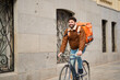 © Oscar - Delivery courier cycling providing urban food delivery service