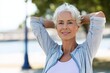 © Iryna - Mature caucasian woman relaxing outdoors with hands behind head on a sunny day