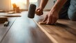 © nicole - Tightening Laminate Floor Joint with Mallet and Block