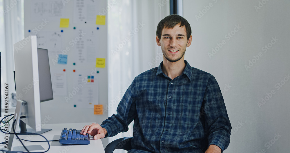 Portrait confident smiling male programmer working with robotics code ...