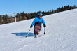 © Alex - a man in a blue jacket demonstrates the correct technique for descending a mountain