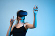 © Volodymyr_sh - Virtual reality interaction with woman using VR headset, immersive experience and modern digital technology