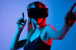 © Volodymyr_sh - Woman pointing at virtual interface while wearing VR headset, immersive gesture control and futuristic technology