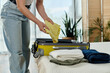 © Bliss - Packing clothes in a modern apartment for a weekend getaway