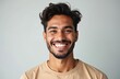 © miss irine - Young Hispanic man smiles broadly, showing perfect white teeth. Looks friendly, happy with light beard. Confident guy poses for studio portrait. Wears simple t-shirt. Joy, positive emotion on face,