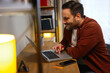 © djile - Relaxed man managing personal finances at home