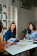 © PaeGAG - Businesswomen collaborating on marketing strategy during office meeting