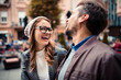 © Davor - Happy couple laughing at outdoor cafe