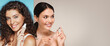 © Prostock-studio - Two women are in a collage, each holding beauty products. They are smiling and engaged in a beauty ritual. This scene appears to take place indoors with a simple background.