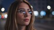 © Vasiliy - Portrait of a young woman wearing glasses at night. Reflection of city lights in eyewear. Urban lifestyle and vision concept