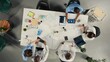 © DC Studio - Top down view of diverse professionals collaborating in brainstorming session. Team shares medical expertise and diagnostic solutions for improved therapy at clinic.