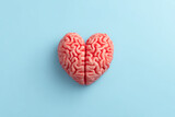 Human brain shaped like heart on light blue background symbolizing love and intelligence in creative concept