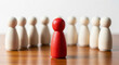 © Asaduzzaman - Red pawn standing out among white pawns on a wooden board, symbolizing leadership and uniqueness in a competitive environment
