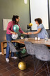 © wavebreak3 - African american couple decorating table with metallic balloons while handing glass, dining room