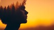 © Tanakrit - A silhouette of a person with a forest overlay against a vibrant sunset background, symbolizing connection with nature and introspection.