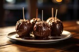 Plate of gourmet chocolate caramel apples dessert table food.