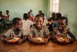 © Meow Creations - Joyful african children eating a healthy lunch of rice and vegetables in a rural school classroom