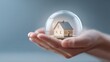 © TensorSpark - Hand holding miniature house inside protective glass bubble symbolizing home warranty and risk assessment, safety and coverage concept.