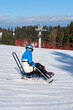 © Alex - A wheelchair user controls the speed of a monoski descent down a mountain