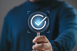 © Bordinthorn - Magnifying glass highlighting a check mark icon, representing verification, approval, quality control, successful validation, compliance process, and confirmation of completed tasks.