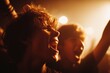 © AnnaStills - Two Caucasian teenagers cheering and singing with mouths open, raising arms at concert, faces illuminated by stage lights, expressing excitement and energy in crowded music event