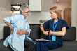 © brizmaker - Healthcare professional visits elderly woman at home for medical consultation