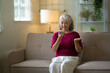 © mojo_cp - senior woman speaks to smartphone AI voice assistant in her home