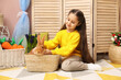 © New Africa - Little girl with cute Easter bunny in wicker basket indoors